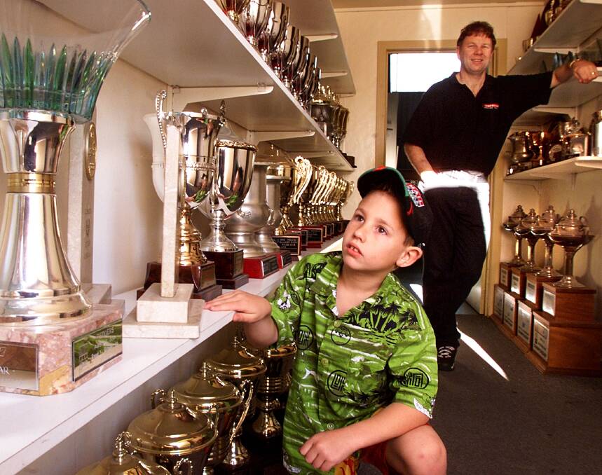TIME FLIES: Brad Jones and a seven-year-old Macauley Jones in the trophy room in 2001. Macauley will drive at Bathurst this weekend.