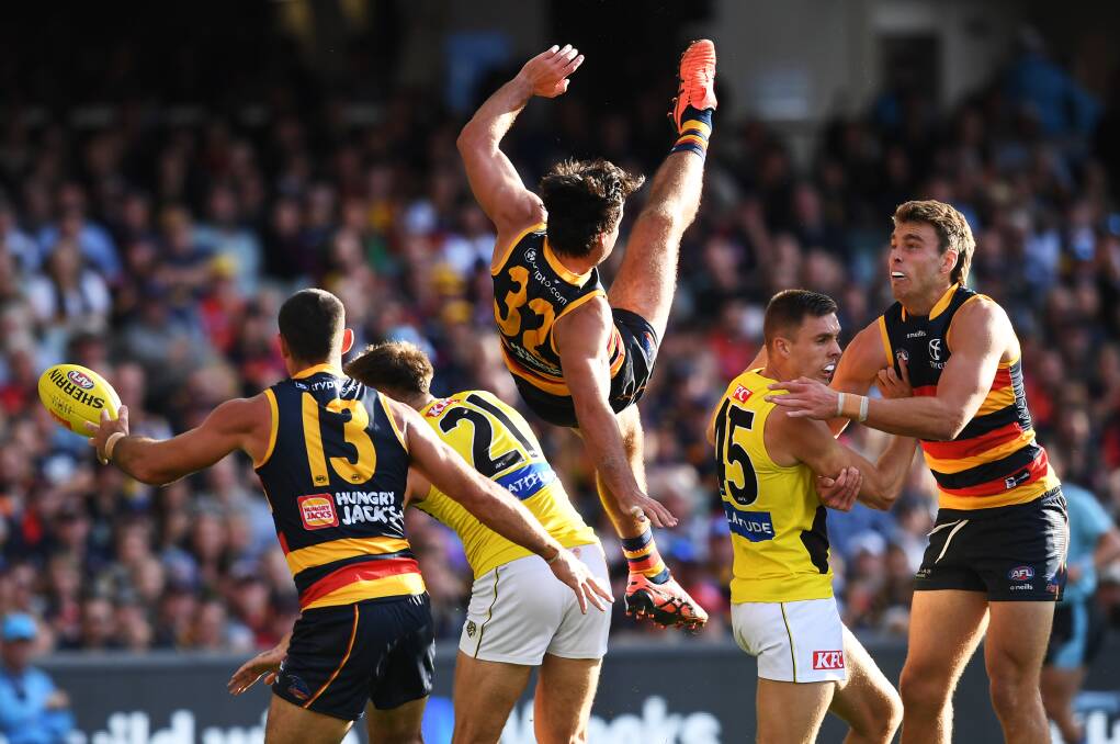 Richmond's Tylar Young (second from right) marks his Adelaide opponent as the action unfolds behind him on Saturday. The Tigers won by 32 points. Picture by Getty Images