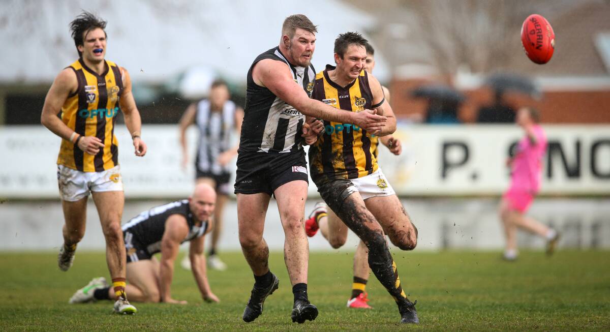 Wangaratta's Zac Leitch (centre) battles Wangaratta Rovers' Shane Gaston when the teams last met. The league hopes they play the qualifying final.
