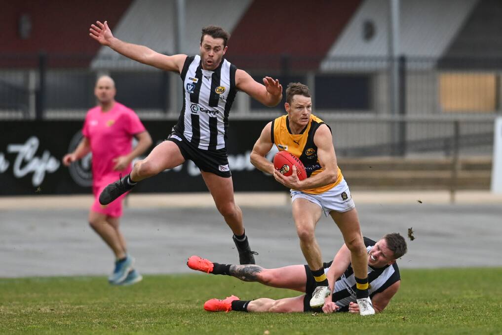 Albury's Luke Daly beats the tackle of Wangaratta's Mark Anderson, while team-mate Liam McVeigh avoids him in the game on Saturday, July 22. Picture by Mark Jesser
