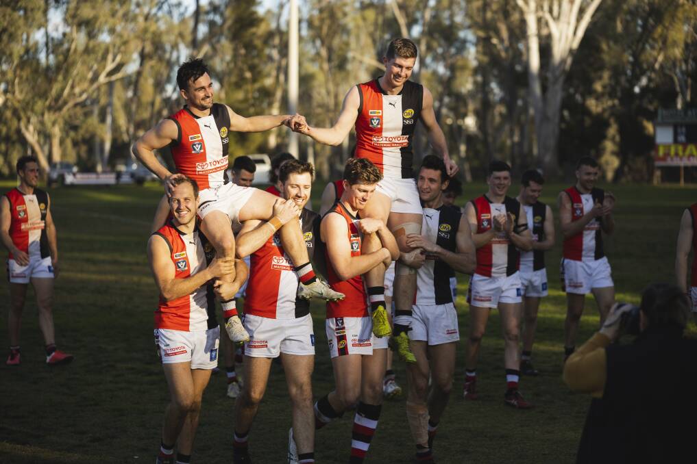 TON UP: Myrtleford's Brody Ricardi (left) and Brady Sharp are chaired off after playing their 100th games in the 63-point win. Picture: ASH SMITH