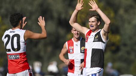 Myrtleford's Charlie Crisp (right) celebrates one of his three goals against Wangaratta last week. Picture by Mark Jesser