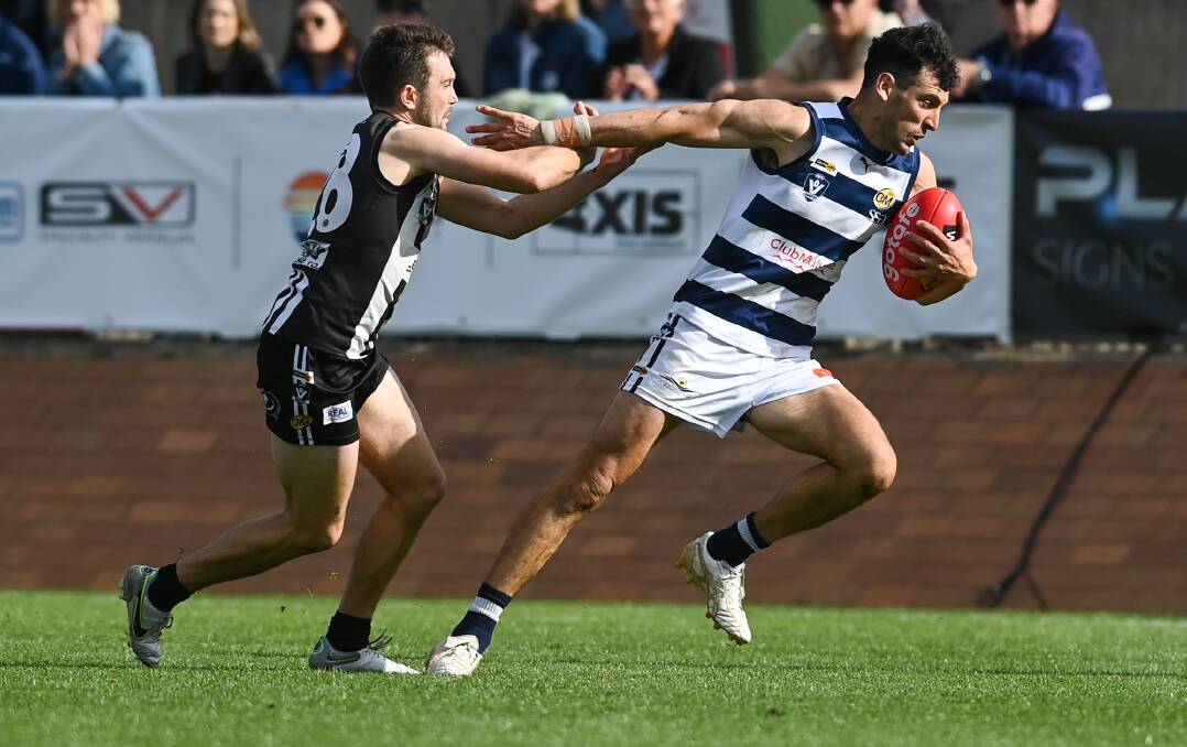 Yarrawonga's Leigh Masters tries to push away from the Pies' Abraham Ankers in a tense moment in the decider. 