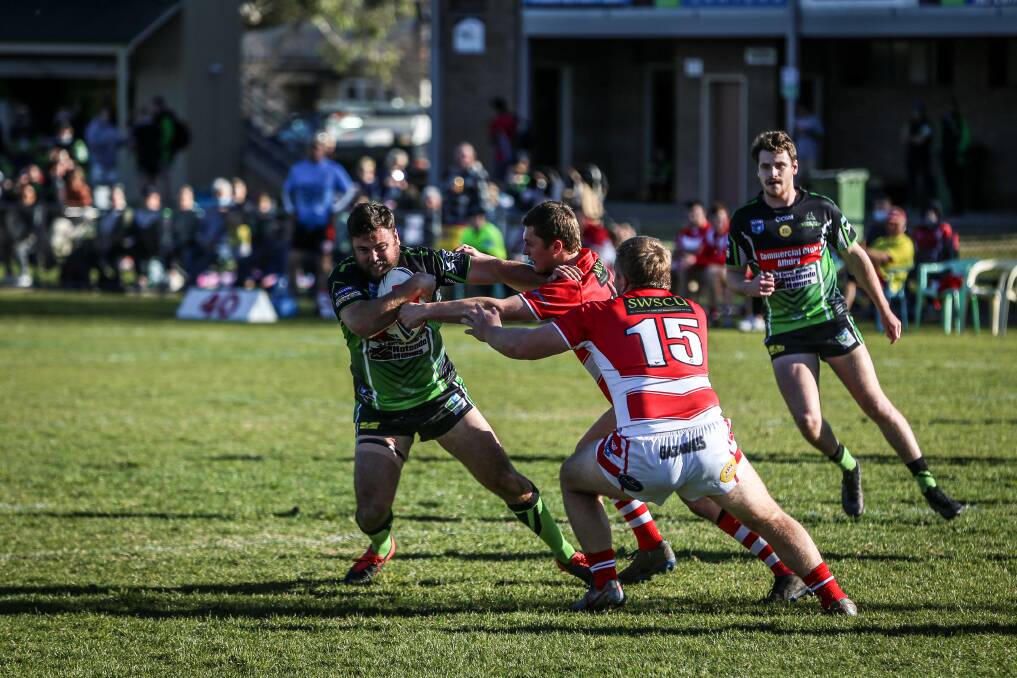 Albury Thunder's Robbie Byatt (left) tries to beat the Temora defence on July 11. It was the Border club's last game due to a bye and two COVID-enforced forfeits.