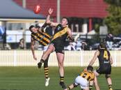 Albury's Isaac Muller (centre) dominated the ruck against Wangaratta Rovers' Shane Gaston. Picture by Mark Jesser