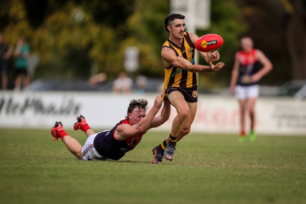 Jack Gerrish is extremely difficult to catch and Wodonga Raiders' Hayden Clarke does his best to rein him in during the Easter clash.