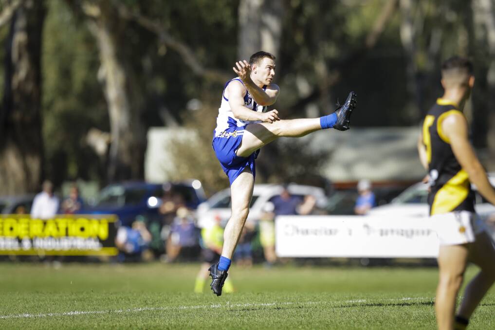 Jy Lane is captured in mid-air as he launches the ball against Albury over Easter. The next time Lane played the Tigers he dislocated his shoulder.