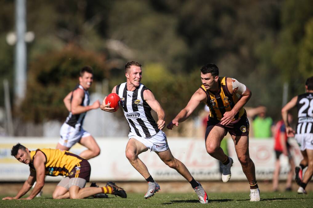 Rovers' Ed Dayman strives desperately to catch Wangaratta's Luke Saunders earlier this year. Dayman is leaving the O and M as he moves to Geelong.