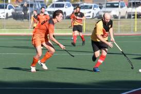 Falcons' Byron Dicks applies pressure to United's Tim Smith. Picture by Hockey Albury Wodonga