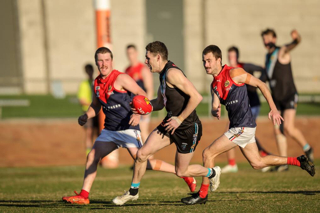 Lavington's Nick Newton pushes away from Wodonga Raiders in the round 10 clash. Picture by James Wiltshire