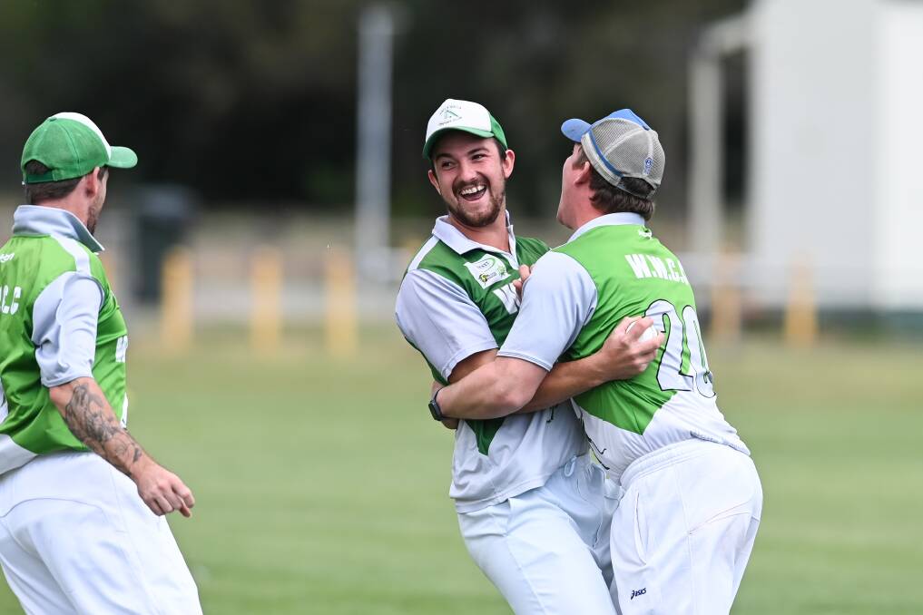 Walla's Mitch Lauritzen (middle) celebrates taking the catch to dismiss opener Mitch Koschitzke. Picture by Mark Jesser