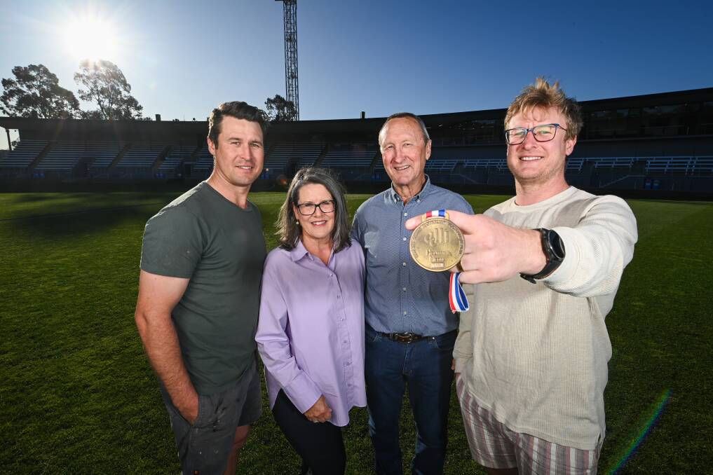 The Holman family will be inducted into the AFL Queensland Hall of Fame in November, with sons Kris (left) and Tom supporting mum and dad Donna and Peter. Picture by Mark Jesser