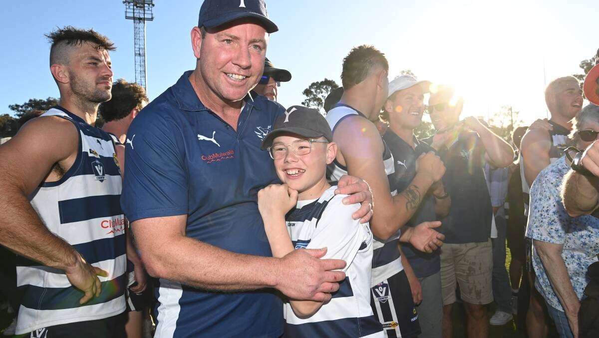 Yarrawonga coach Stevie J shares a moment with his son after the epic grand final victory. Picture by Mark Jesser