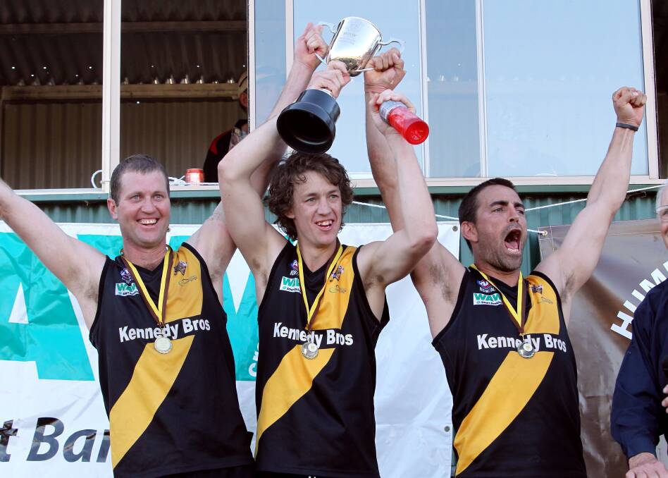 McAlister holds the premiership trophy aloft in 2012.