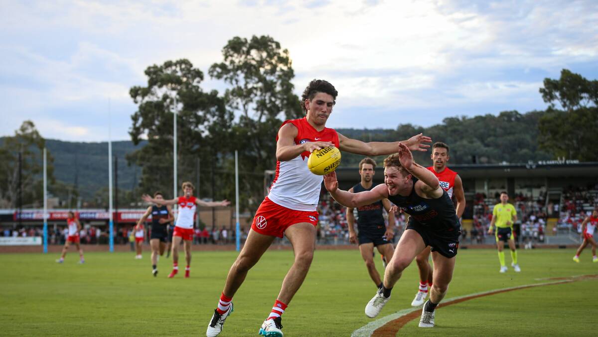 IN SPACE: Sydney Swans forward Sam Wicks finds some space as his GWS Giants opponent closes in.