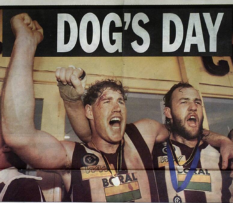 Wodonga's two big men in Brett Allen and Steve Murphy belt at the club song after the premiership victory over Lavington.