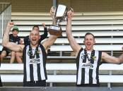 Ben Reid and Mick 'Juice' Newton hold the premiership cup aloft after the 2022 grand final win against Yarrawonga. Picture by Mark Jesser