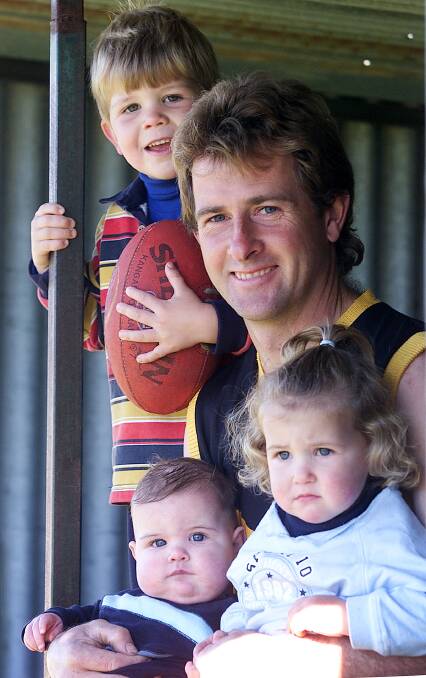 Kevin Wardius with his children Damian, (top), Hayden, (bottom left) and Caitlyn in 2003.