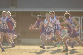 Beechworth coach Tom Cartledge bursts clear with Roos skipper Ben McIntosh in hot pursuit. Picture by James Wiltshire