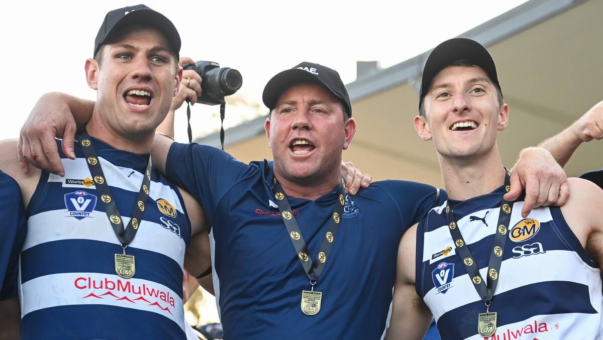 Lach Howe, Steve Johnson and Matt Casey belt out the club song after their epic grand final win. Picture by Mark Jesser