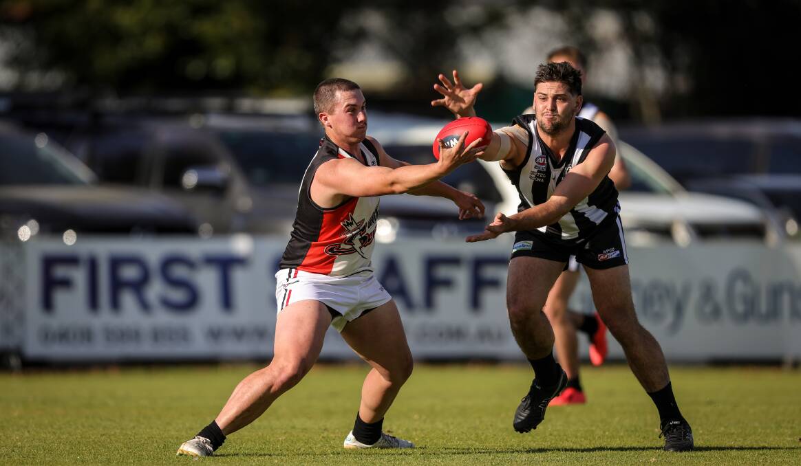 Brock-Burrum's Oliver Robertson juggles the Sherrin as his Magpies opponent applies the pressure at Urana Road Oval on Saturday. Picture by James Wiltshire