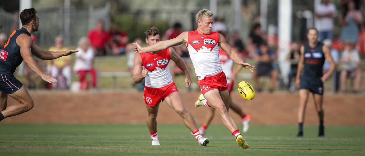 CLASSY: Isaac Heeney sends the Sydney Swans into attack on his penetrating left boot.