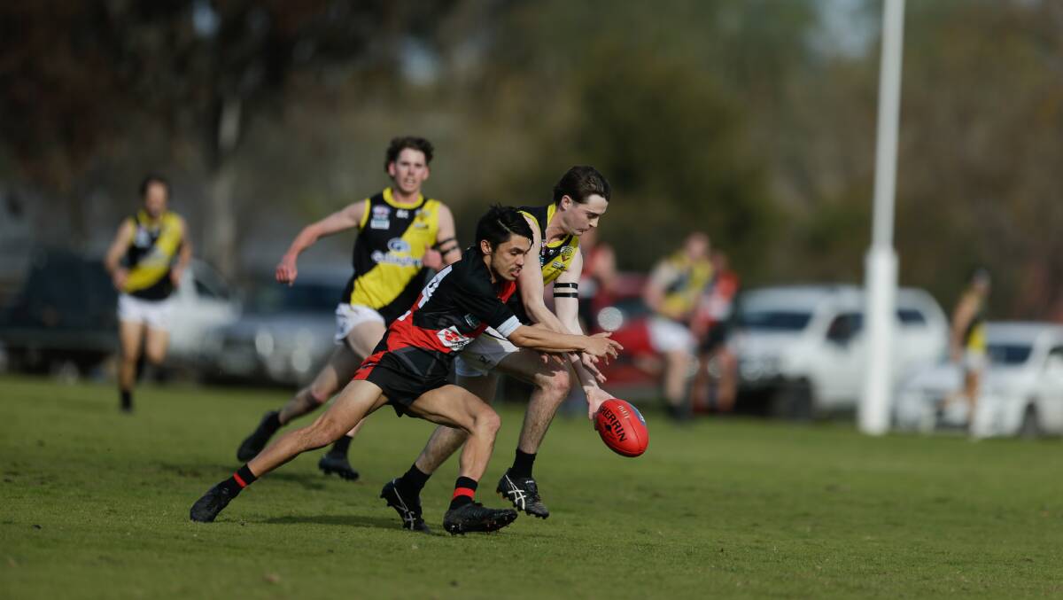 Howlong speedster Bradley Fyffe and Macauley Armstrong battle for possession.