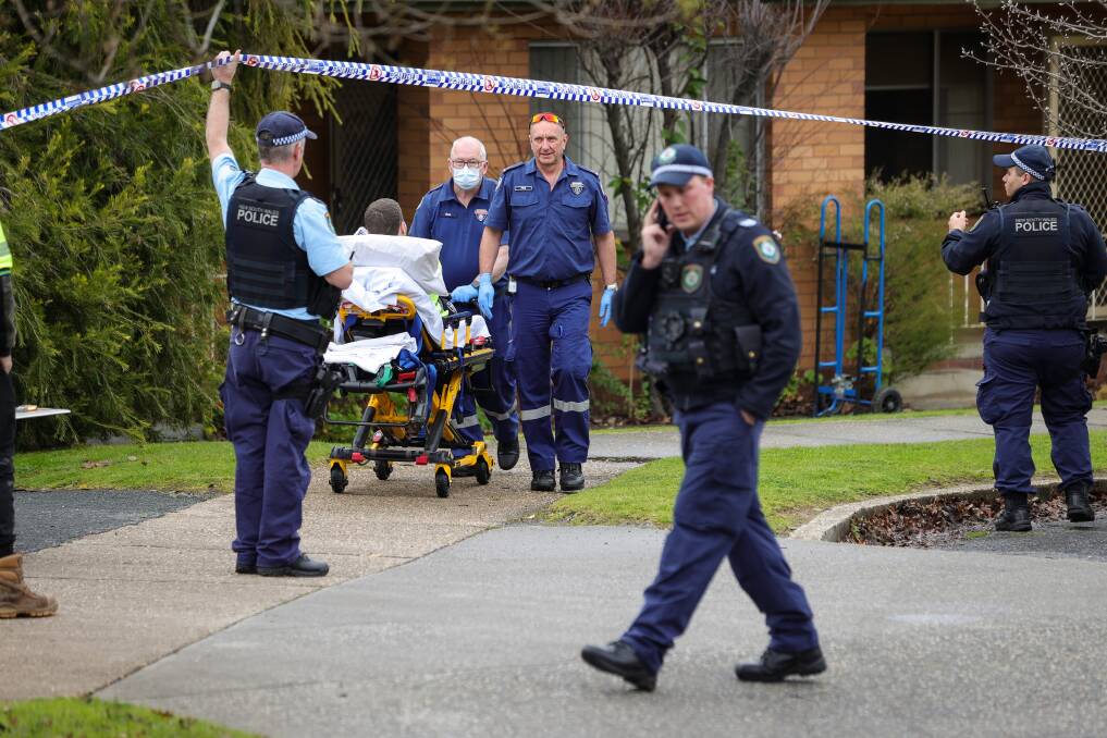 Albury police and paramedics help to escort a man from Schubach Street in East Albury on Monday, July 10. Picture by James Wiltshire