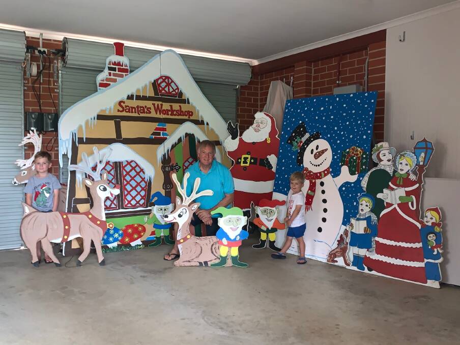 CHRISTMAS JOY: Col Johnson with his new neighbours, Flynn, 5 and Beau, 2, Hanckel, who had eagerly awaited his decorations to be displayed at his Thurgoona home.