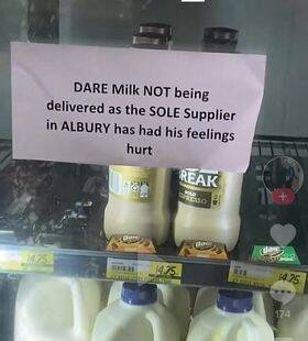 Norris Park IGA displayed signs on its milk fridges to explain the absence of a popular variety. Picture supplied