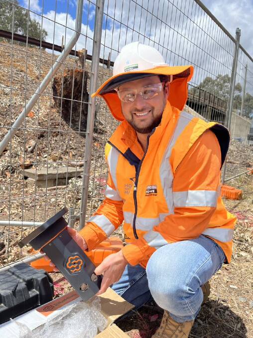 McConnell Dowell environment and sustainability manager Steve Eeles holding the site hive, which he says is reducing the impact of Inland Rail works on the community.