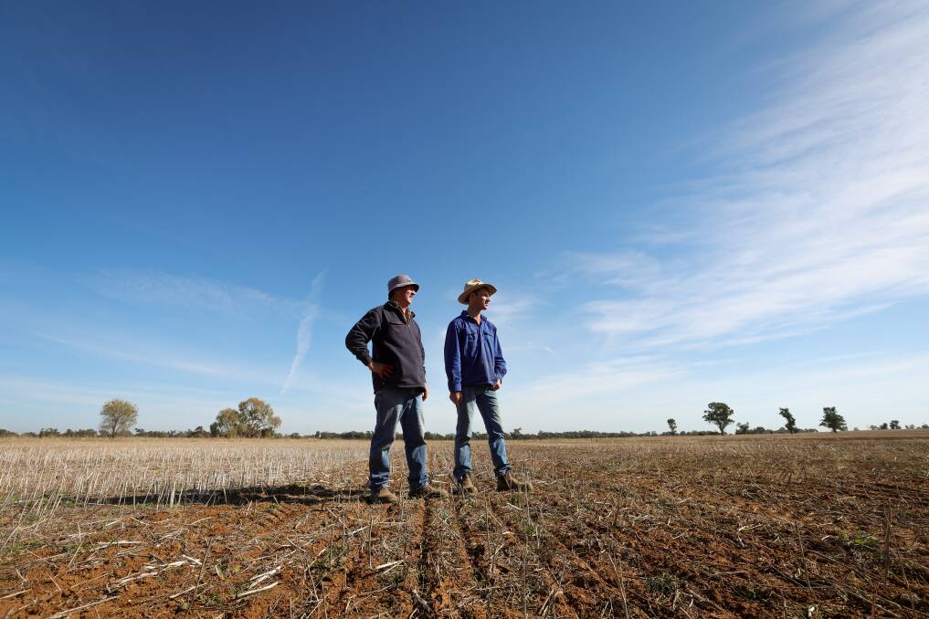 Urangeline East farmers Rick and Tom Clancy inspect their property, which is in need of rain to ensure steady growth to help with diminishing stock feed. Picture by James Wiltshire