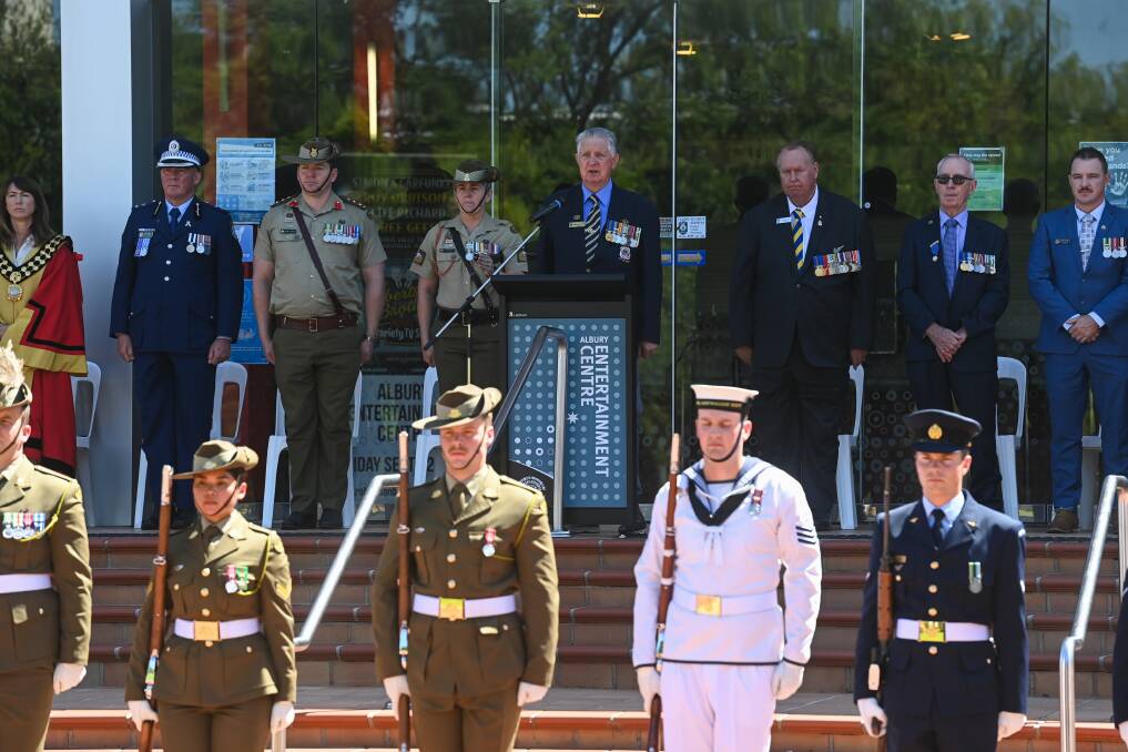 Albury mayor Kylie King (far left) prepares to address the gathering at QEII Square on Saturday for the 50th anniversary of the withdrawal of Australian soldiers from the Vietnam War, moments after she tended to an emergency with a former Albury mayor. Picture by Mark Jesser