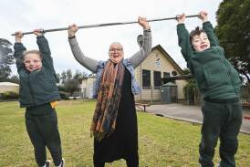 Alison Bruce lifts Lowesdale Public School year 1 students Daisy Cocking, 6, and Archie Taylor-Ware, 7, before she flies to Paris to watch her son, Kyle, compete in his first Olympic Games in the men's 89kg weightlifting. Picture by Mark Jesser