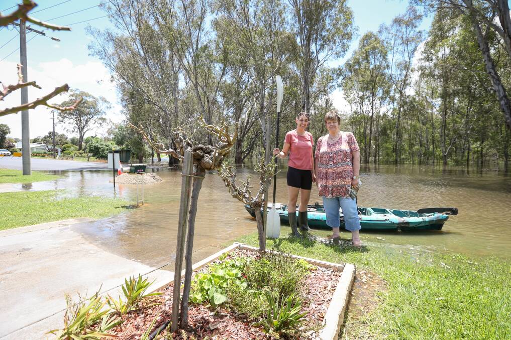 Wahgunyah neighbours Justine Smith and Jenny Hovard lost access to their driveways on Barkly Street as flooding in parts of the riverside town worsened on Monday. Picture by James Wiltshire