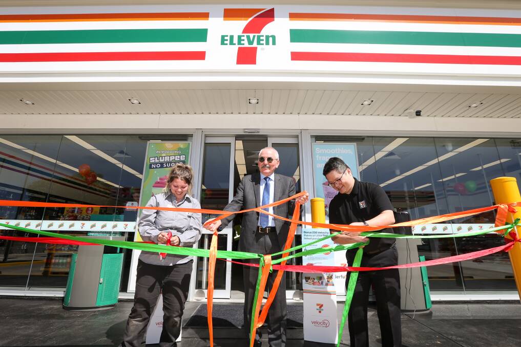 Store manager Amy Dosser, Wodonga mayor Ron Mildren and operations performance chapter member Tim Loi untying ribbons for the opening of a new 7-Eleven shop on High Street on Tuesday. Picture by James Wiltshire