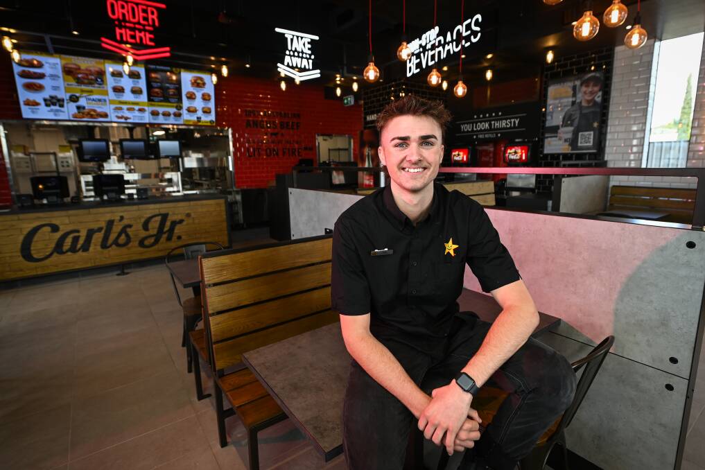 Carls Jr restaurant manager Liam Goodacre is helping to prepare for the opening of the new Wodonga store, which will see the first 50 customers win free burgers for a year. Picture by Mark Jesser