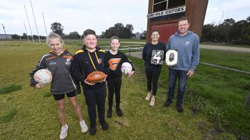 Lexi McCall, 11, Max McClellan, 12 and Ivy Kreutzberger, 11, Amanda McCall and James Kreutzberger are looking forward to the 40th edition of the Rand Public School P&C Association football-netball development carnival. Picture by Mark Jesser