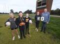 Lexi McCall, 11, Max McClellan, 12 and Ivy Kreutzberger, 11, Amanda McCall and James Kreutzberger are looking forward to the 40th edition of the Rand Public School P&C Association football-netball development carnival. Picture by Mark Jesser