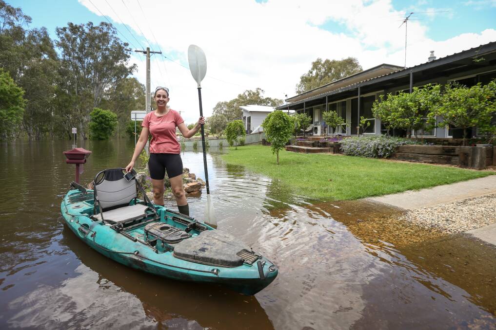 Wahgunyah resident Justine Smith was required to use a kayak to access her home on Barkly Street on Tuesday as floodwater continues to inundate the riverside town. Picture by James Wiltshire