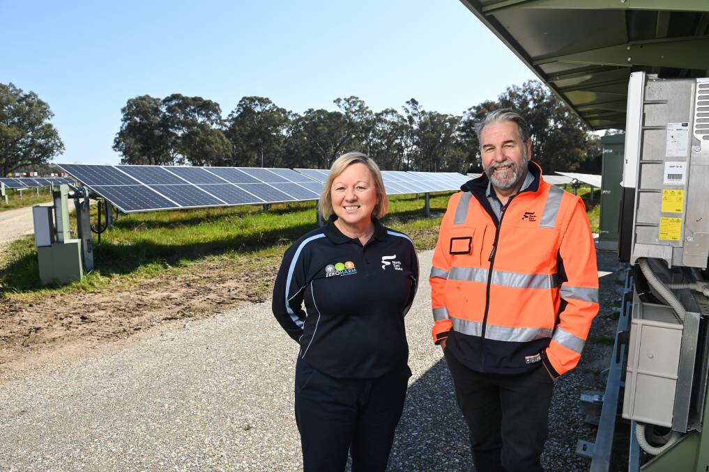 North East Water managing director Jo Murdoch and general manager of environment, systems and operations John Day at the new $9 million, 6500-panel, solar farm on Old Barnawartha Road in West Wodonga, which will help the water provider cut energy costs of its wastewater treatment plants. Picture by Mark Jesser