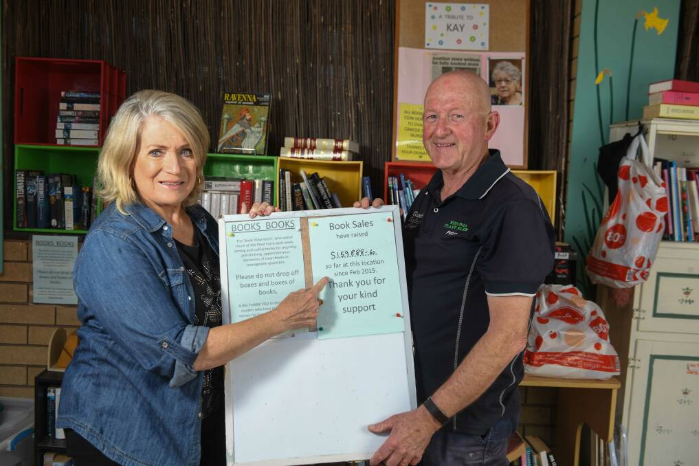 Heather Watts and Wodonga Plant Farm's Peter Boyle with the tally of funds raised from the $1 bookstore. Picture by Tara Trewhella 