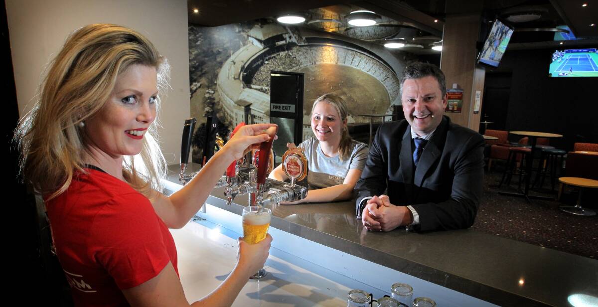 POPULAR BOSS: Team leaders Liz Street and Sarah Murphy with Mr Levesque in the club's new sports bar.