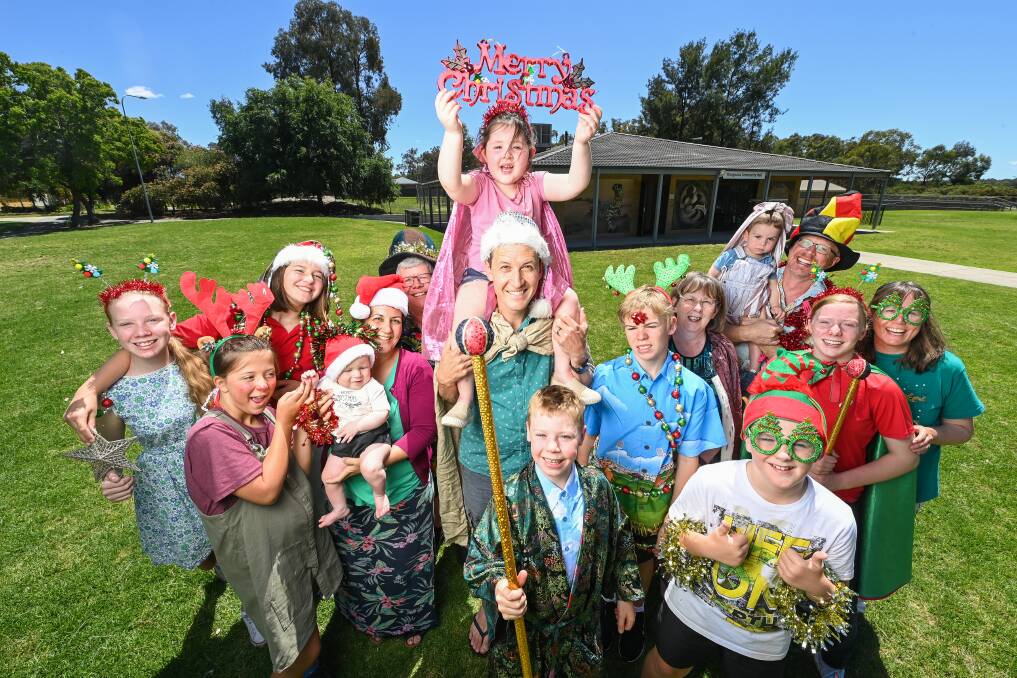 CAROLS ON: Thurgoona Presbyterian Church Pastor Dave Hayes, Sophie Oldfiend, 5, and families connected to the church are getting in the spirit ahead of the Albury Community Carols running on Wednesday and Thursday. Picture: MARK JESSER