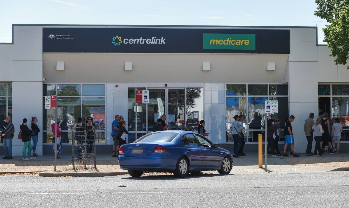 People queue at Centrelink in Albury in March, after JobSeeker payments were made available. Picture: MARK JESSER