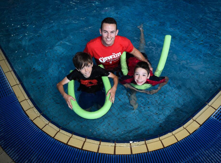 HEADS ABOVE WATER: YMCA health and fitness coordinator Matt Frost and Belvoir Special School students Sam Barker, 12, and Cameron Bye, 12. Picture: MARK JESSER