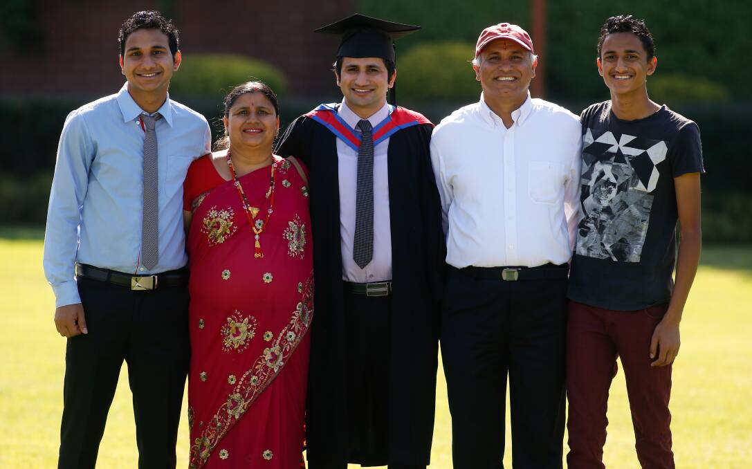 FAMILY PRIDE: Brother Ram and mother Naina celebrate Dilli Khanal's graduation with his father Nila and brother Narayan. Picture: MARK JESSER