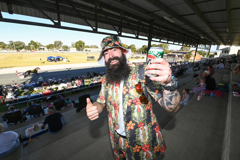 ON THE BEERS: Kirt Perry, of Wodonga, dressed in his VB suit, in a half-full grandstand at the Albury Harness Racing Club. There were some cancellations due to COVID. Pictures: MARK JESSER