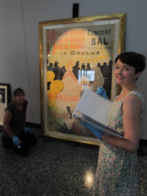 SHOWPIECE: Mary-Lou Nugent and Julia Greenstreet check drawcard Moulin Rouge La Goulue. Picture: PETER DE KRUIJFF
