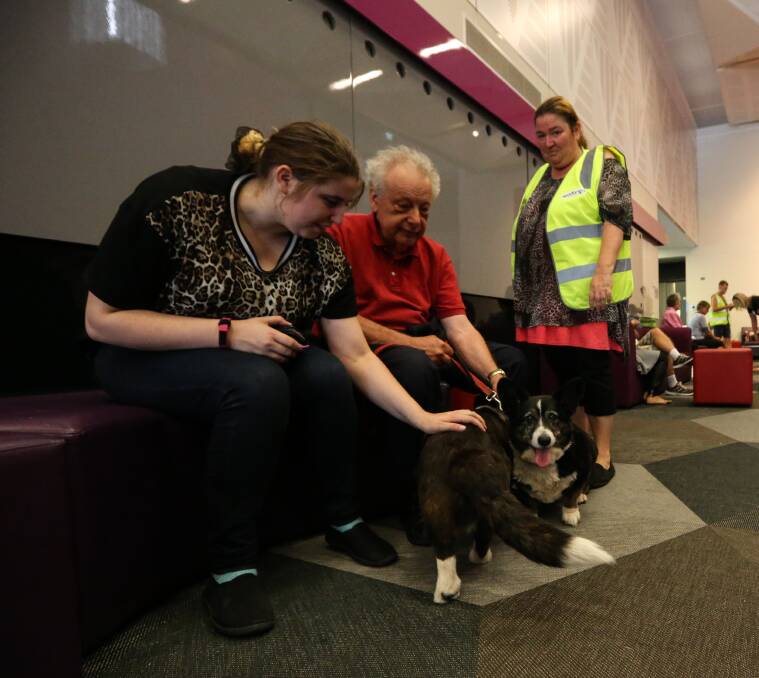 SAFE: Caitlahn Brincat and Charmane Jones with Warren Gould and his dogs. Picture: JAMES WILTSHIRE